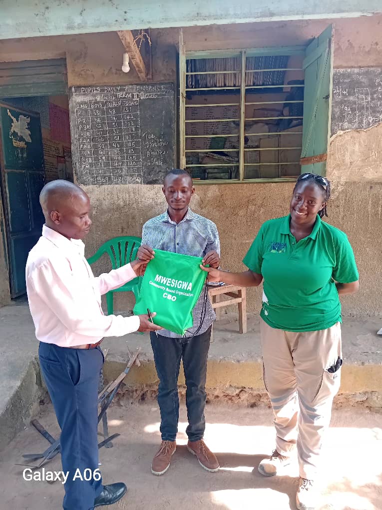Mwesigwa CBO representatives working with pupils during school outreach