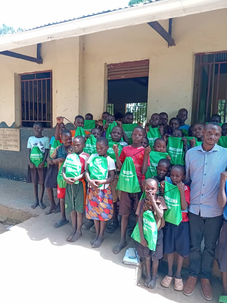 Pupils and Mwesigwa CBO representatives during an outreach activity